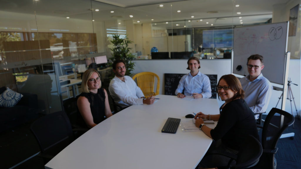 Arch Capital Team around a board room table